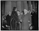 Interior Secretary Ickes congratulates Marian Anderson at concert. Washington, D.C., April 9. Secretary of the Interior Harold Ickes, who introduced Marian Anderson at her open-air concert at the shrine of the president who freed her race from slavery, congratulating her after the concert to which an estimated 75,000 listened