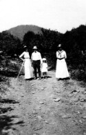 Two unidentified women, a man, and a little girl