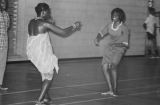 Viola Bradford learning a traditional African dance in a gymnasium, probably in Montgomery, Alabama..