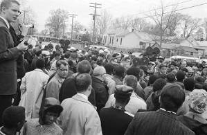 Civil rights demonstrators, journalists, and law enforcement officials gathered on Sylvan Street in front of Brown Chapel AME Church in Selma, Alabama.