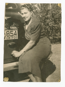 Photographic print of a woman sitting on rear bumper of a car