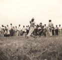 African American serviceman hitting the ball at the Calhoun County championship softball game.