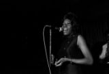 Woman performing on stage with Bobby Moore and the Rhythm Aces during a New Year's celebration at the Laicos Club in Montgomery, Alabama.