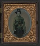 [Unidentified young soldier in Union frock coat and infantry Hardee hat with sword, revolver, and fife]