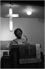 Woman singing before an audience at Hall Street Baptist Church in Montgomery, Alabama.