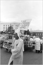 Klansman carrying a sign at a Ku Klux Klan rally in Montgomery, Alabama.