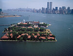 Aerial view of the Ellis Island immigration station showing the World Trade Center buildings in the distance. New York, New York