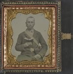 [Unidentified soldier in Confederate uniform and C.S.A. belt buckle with cartridge box and percussion cap box, holding a book]