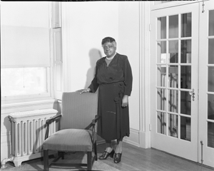 Mary McLeod Bethune standing near chair : acetate film photonegative