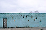 Portraits and phrases of Malcolm X, MLK, Jr., and others in a memorial mural on a wall along Route 30, Ford Heights, Ill., 1980