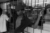 James "Bubba" Bradley standing in front of the barred window of Pugh's Superette on Foster Street in Newtown, a neighborhood in Montgomery, Alabama.