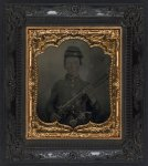 [Unidentified young soldier in Union shell jacket and forage cap with revolver and musket]