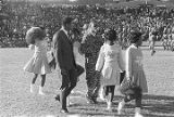 Muhammad Ali on the football field with the mascot and cheerleaders from Tuskegee Institute during homecoming activities for Alabama State College on Thanksgiving Day in Montgomery, Alabama.