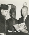 John Glenn and Boy Scouts reading a book