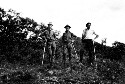 Three unidentified men with walking sticks