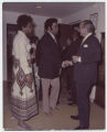 Bob Simms and his wife greeting a gentleman