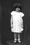 Portrait of a girl standing on a chair