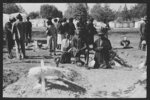 Negro family praying at graves of their relatives on All Saints' Day, New Roads, Louisiana