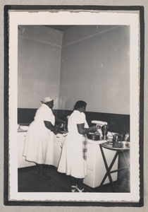 Photograph of two African American women cooking in a kitchen, Clarkesville, Habersham County, Georgia, 1950