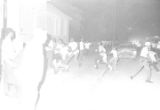 Several young men running on a neighborhood street during a civil rights demonstration in Montgomery, Alabama, after police had blocked a march and ordered the participants to disperse.