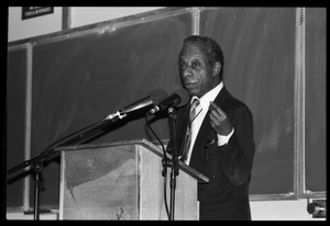 James Baldwin lecturing at UMass Amherst Baldwin standing at a podium with microphones