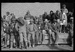 Negro flood refugees wearing identification tags after registration in the concentration camp at Forrest City, Arkansas