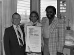 Taylor Billingslea posing with others in his office, Los Angeles, 1983