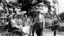 Thumbnail for Unidentified group on a horse drawn buggy. Helen Davis sitting closest to man and Ruth Davis is sitting on the back of the buggy