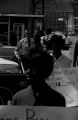 Protestors carrying signs while marching past businesses in downtown Prattville, Alabama, during a civil rights demonstration.