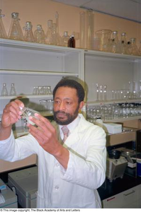 Photograph of Dr. Edison Fowlks holding a Erlenmeyer flask