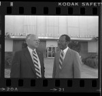 Ivan Houston and Larkin Teasley of Golden State Mutual Life Insurance Co. standing before company's building in Los Angeles, Calif., 1984