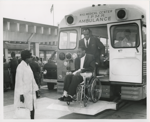 Man in wheelchair getting out of ambulance