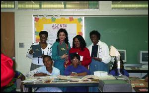 Women Presenting Books with Gates Elementary Students