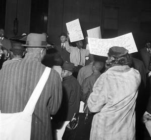 Demonstrators in the rain at a voter registration rally outside the Jefferson County courthouse in Birmingham, Alabama.