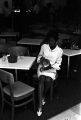 Barbara Howard Flowers, staff member at the Southern Courier, seated at a table at the Elks Club in Montgomery, Alabama.