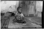 Negro child on porch of dilapidated Trepagnier plantation near Norco, Louisiana