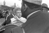 Female reporter talking to a man on Auburn Avenue on the day of Martin Luther King, Jr.'s funeral.