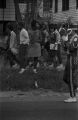 Bystanders at a homecoming parade through a neighborhood in Montgomery, Alabama.