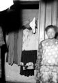 Woman standing near an open closet in an apartment