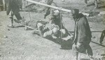 Coolies Carrying Wounded Rebels to the Rear, China 1911