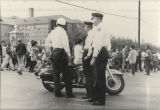 Three policemen watching marchers in Montgomery during the Selma to Montgomery March.