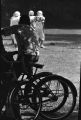 Young man on a bicycle, watching football players from Baldwin Junior High School in Montgomery, Alabama, practice in a yard on Clayton Street.