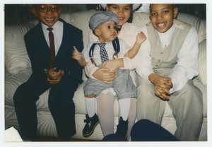 Four children sitting on a couch.