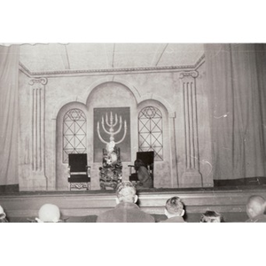 Woman kneels before a man in a pageant