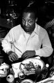 Robert Flowers seated at a table at the Laicos Club in Montgomery, Alabama, during a performance by the Sheiks.