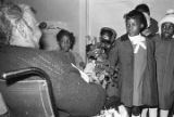 Children in the group "Buds of Promise" from Mt. Zion AME Zion Church in Montgomery, Alabama, singing to an elderly woman in her home.