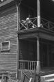 Jasper Wood Collection: Man sitting on second floor porch