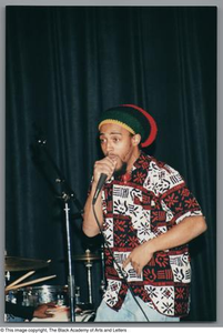 Photograph a man rapping into a microphone