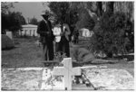 Negro couple at grave of relative, All Saints' Day in Cemetery at New Roads, Louisiana