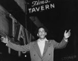 Man standing in front of Tim's Tavern, 1111 E. Pike St., Seattle, October 26-28, 1956